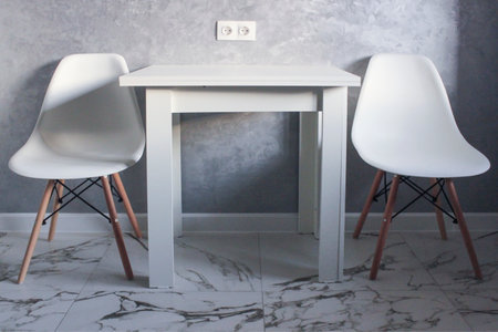 Kitchen table and chairs on gray wall backgroundの写真素材