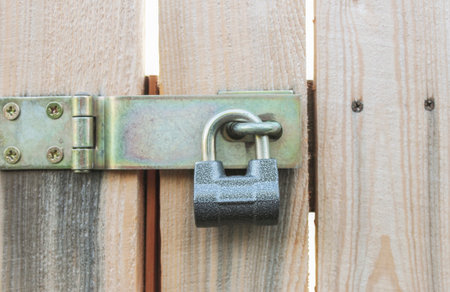 Padlock on a deadbolt gate in a garden close-up