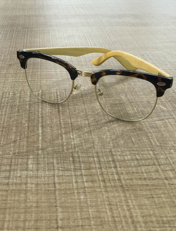 Glasses on wooden office table with copy spaceの写真素材