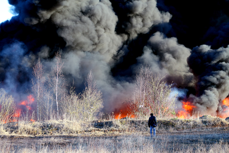 Fire outdoors with black clouds of smokeの写真素材