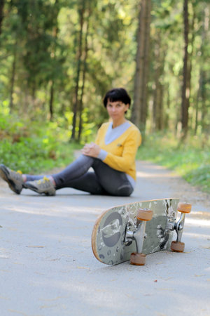 Athletic girl in the park on a skateboard