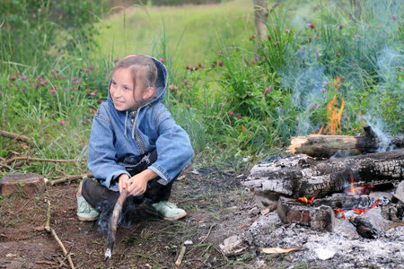 girl by the fireの写真素材