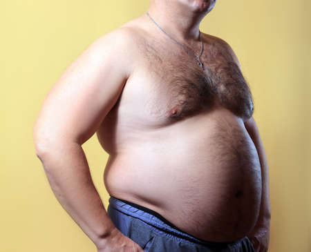 fat man on yellow backgroundの写真素材