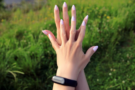 Female hands on the background of nature
