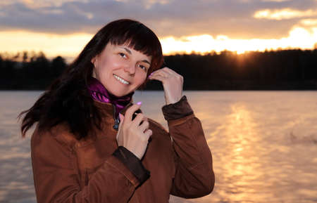 portrait of a woman on a sunset backgroundの写真素材