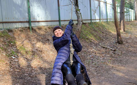 portrait of a woman on a swingの写真素材