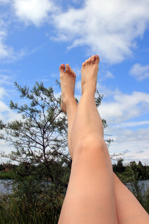 women's feet on the beachの写真素材