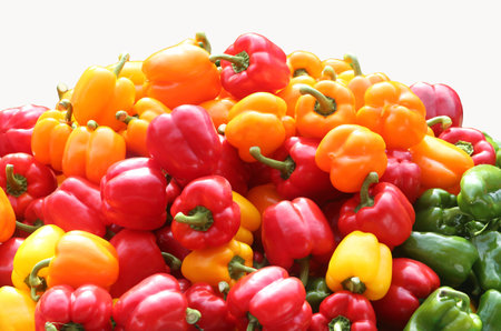 Red green and yellow  bell pepper on white background