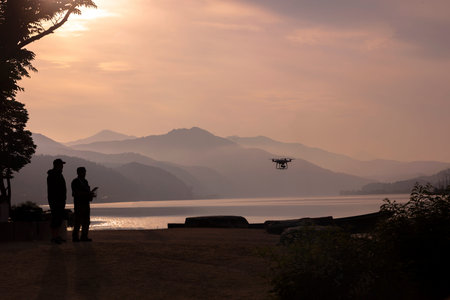 Drone Flying in The Sky with  lake and Mountain at Sunrise