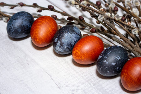 red and blue easter eggs with willow branch on the table
