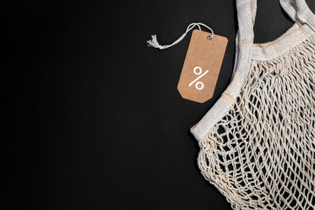 Bag and price tag on black backgroundの写真素材