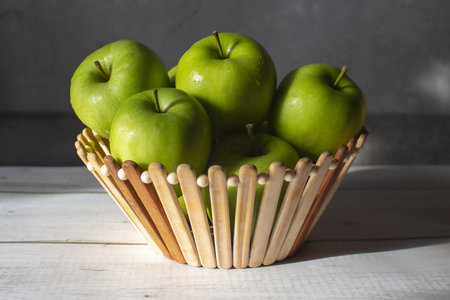 Green apples in a wooden bowl