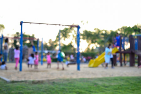 Colorful playground with children and parents in park (blur background)の写真素材
