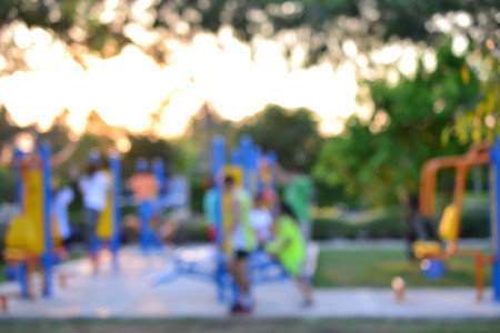 Colorful playground with children and parents in park (blur background)の写真素材