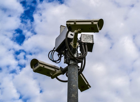 Security camera on blue sky backgroundの写真素材