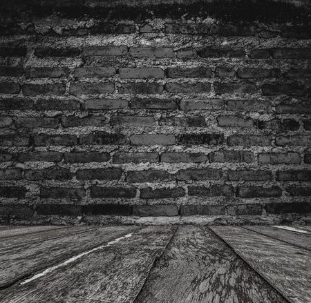 Dark room with wood  floor and brick wall backgroundの写真素材