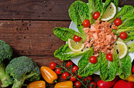 Fried salmon chopped into slices with vegetablesの写真素材