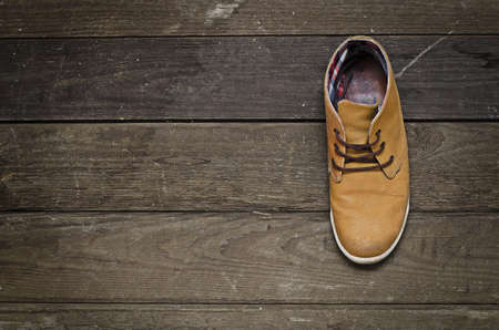 Old boot on the old boardの写真素材