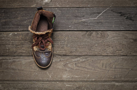 Old leather shoe on the worn boardの写真素材
