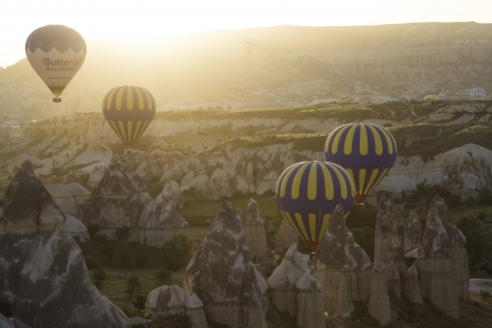 Hot air balloon flying over rock landscape at Cappadocia Turkeyのeditorial素材