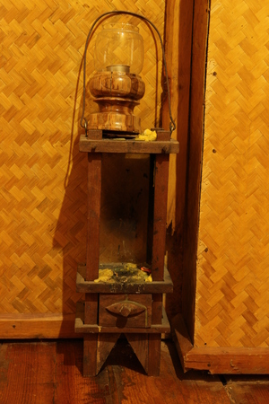 Old lantern on the wooden shelf with bamboo の写真素材