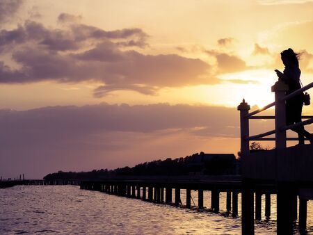 The silhouette of the sunset at the seafront terrace.の写真素材