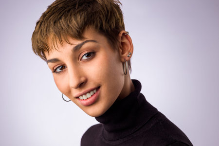 Spanish hispanic young woman headshot insolated in a white background. Smile face from a pretty model with short hair.の写真素材