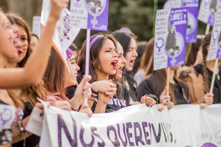womens international day in madrid protest and demostration for equality and women right. A crowd of people march in Madrid with violet colours and mee too symbolsのeditorial素材
