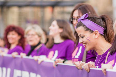 womens international day in madrid protest and demostration for equality and women right. A crowd of people march in Madrid with violet colours and mee too symbolsのeditorial素材