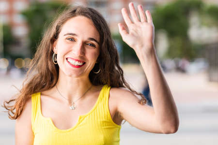 Hispanic young woman using talk technology chat for communication. Happy smile looking at cameraの写真素材