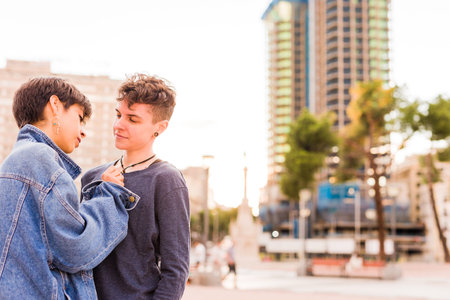 Young Tomboy lesbian couple. Androgynous non binary transgender and a hispanic woman with short hair