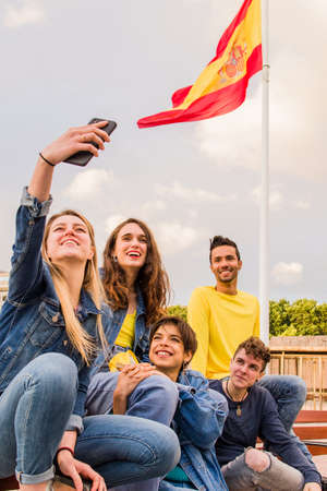 multiethnic young group with diverse ethnic take a selfie with mobile phone in Spainの写真素材