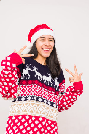 Christmas ugly sweater. Latin venezuelan woman wearing a fashion woolen xmas styleの写真素材