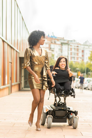 New Year celebration. Wheelchair Dysplasia disability Hispanic woman, healthcare with Cuban friendの写真素材