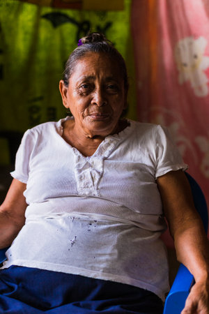 MANAGUA, NICARAGUA - September 18 2018: Nicaraguan poverty. ederly woman lifestyle in her poor homeのeditorial素材