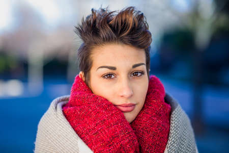 headshot froma a yooung hispanic female. Beautiful woman with an ambiguous hairsylingの写真素材