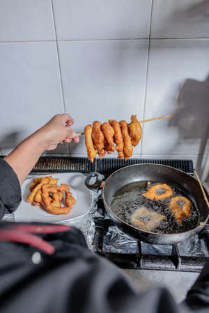 Peru Latin senior chef cooking Picarones in professional small business kitchenの写真素材