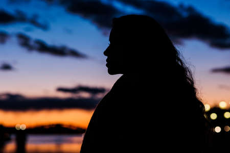 woman silhouette tranquillity sunset background, travel in Tajo river. Toledo, Castilla la manchaの写真素材