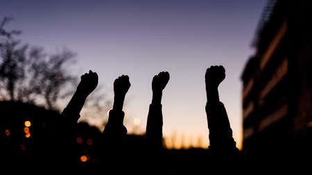 fist silhouette for women day 8 march. multicultural sunset women power demonstrationの写真素材