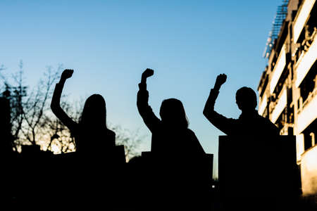 fist silhouette for women day 8 march. multicultural sunset women power demonstrationの写真素材