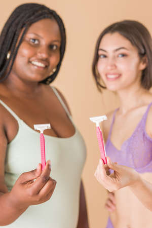 hair removal body care depilation with razor. skin cosmetology with Latin Cuban and Moroccan womanの写真素材