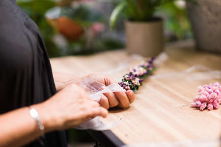 closeup hands Florist small business owner. hispanic mid woman floral arrangement decoration.の写真素材