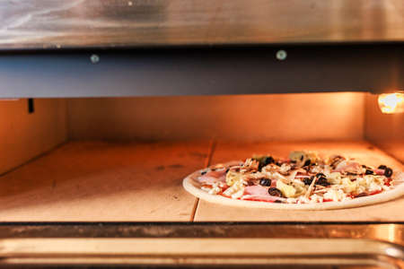 Pizzeria industrial professional metal oven. food close-up in pizza restaurant no people backgroundの写真素材