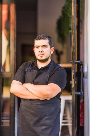 Latin mid chef entrepreneur with professional uniform. successful owner manager. venezuelan manの写真素材