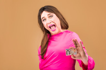 transgender mature woman holding identification document. Gender change equaly lgtbq authenticの写真素材