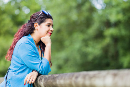 thinking outside in nature wellness self care relaxation. south american woman in senda del osoの写真素材