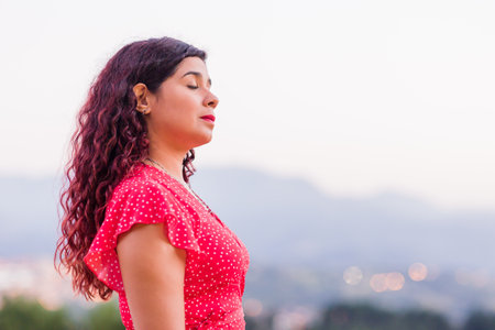 latin people portrait. lifestyle young good-looking woman outside. Calming happiness of Venezuelanの写真素材