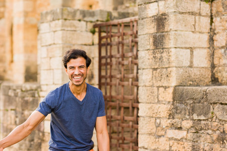 indian mature man handsome portrait with toothy smile standing on isolate copy space backgroundの写真素材
