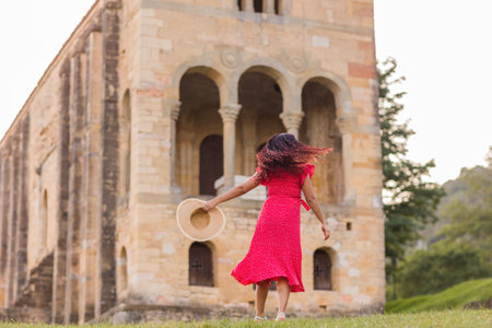 Freedom and success wellbeing getaway. Positive happy dance from latin woman on holiday in Asturiasの写真素材