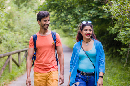 Senda del oso, Teverga Asturias. mixed race travelers couple hiking ecotourism conservation pathの写真素材